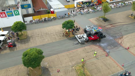 Aerial-View-Of-Monster-Truck-Jumped-Over-Crushed-Cars-During-Team-Lagrin-Stuntshow-In-Lohne,-Germany