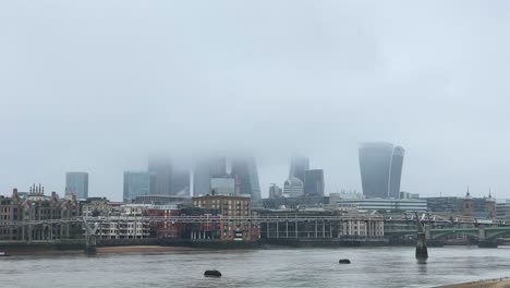 London-city-skyline-and-River-Thames-covered-by-stormy-fog-and-mist