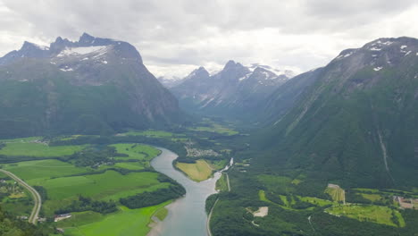 Beautiful-Scenery-Of-Rauma-River-Through-The-Mountains-Of-Romsdalen-In-Andalsnes,-Norway-With-Romsdal-Fjord-Revealed