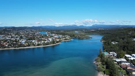 High-drone-view-of-Tallebudgera-Creek-and-estuary-with-a-mountain-backdrop-Gold-Coast-Australia