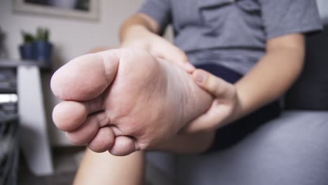 Grasp-the-foot-by-massaging-the-person-who-is-suffering-from-swelling-pain