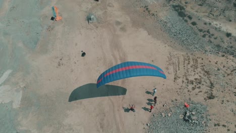 Aerial-View-Of-Paraglider-Preparing-To-Take-Off-From-Coastline-In-Karachi-Pakistan