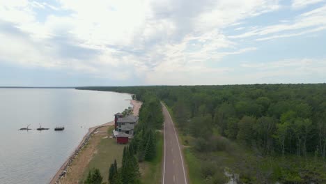 Aerial-view-of-a-road-next-to-Lake-Superior,-highway-scenic-drive,-Madeline-island-wisconsin