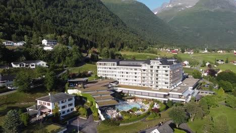 Hotel-Alexandra-Loen-Norway-at-beautiful-summer-day-with-tall-mountains-and-lush-valleys-in-background---Forward-moving-aerial-from-overview-to-close