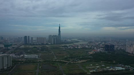 Long-Fly-in-towards-river-and-modern-city-development-with-high-rise-towers-in-early-morning