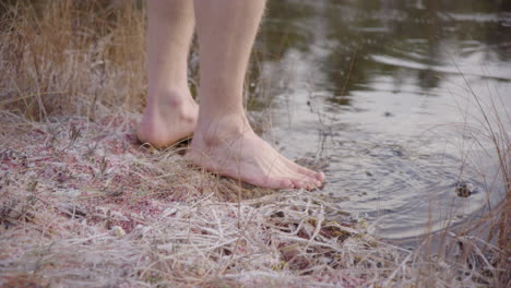 REVEAL-CLOSEUP---Ice-bathers-feet-approach-and-start-breaking-the-ice