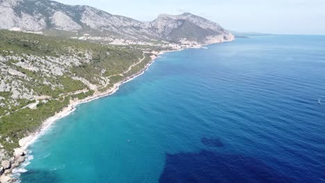 Drone-flight-northwards-with-spectacular-Sardinian-beaches-and-turquoise-blue-sea,-sunny-beautiful-weather