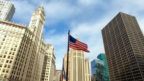 American-Flag-Waving-With-City-Skyline-And-Blue-Cloudy-Sky