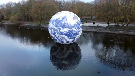 Luke-Jarram-floating-earth-exhibition-aerial-view-at-Pennington-flash-park-lake-turning-left