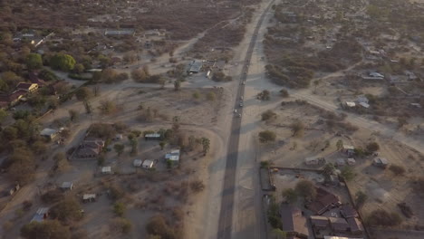 Tracking-aerial:-Highway-runs-through-sandy-desert-town-in-Namibia