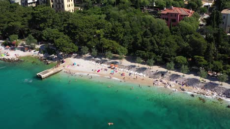 Tourists-Enjoying-At-Scenic-Crikvenica-Resort-Town,-Kvarner-Bay,-Croatia---aerial-drone-shot