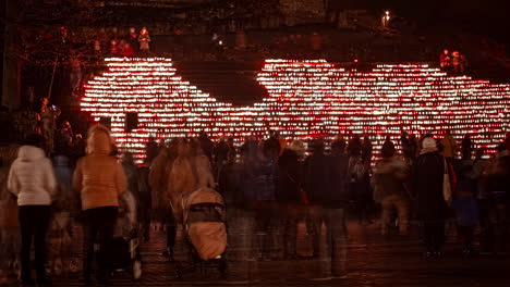 Latvian-People-Outdoors-celebrating-Proclamation-Day-of-the-Republic-of-Latvia---Many-lights-and-candles-in-background-at-night---Time-lapse-shot