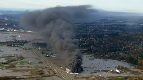Dark-Smoke-Rising-From-Burning-Storage-Yard-In-British-Columbia,-Canada-After-Rainstorm