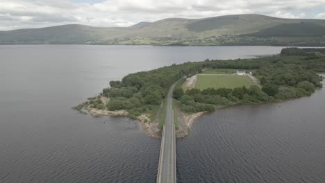 Aerial-View-Of-Cars-On-The-Bridge-Over-Blessington-Lake-In-Wicklow,-Ireland---drone-shot