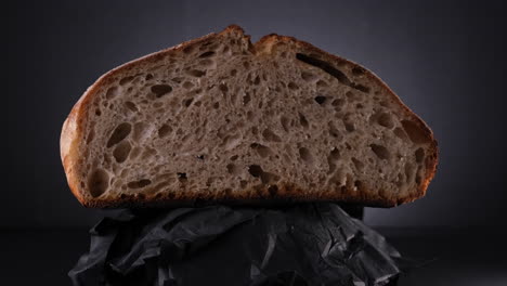Half-Cut-Loaf-of-Sourdough-Bread-Spinning-With-Black-Background