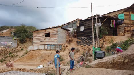 Kids-playing-between-Temporal-Huts-in-Refugee-Camp-or-Slum-in-Colombia