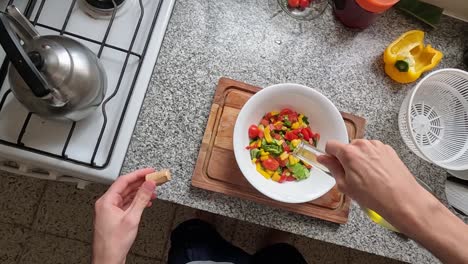 Chef-POV-Adding-olive-oil-to-a-salad-in-the-kitchen