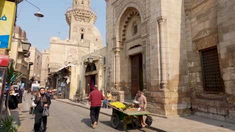Authentic-unique-life-scene-of-Egyptian-people-during-a-working-day-with-mosque-in-background,-Cairo-city-in-Egypt