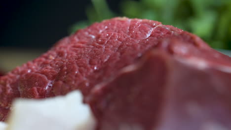 Close-up-of-juicy-raw-beef-steak-in-kitchen