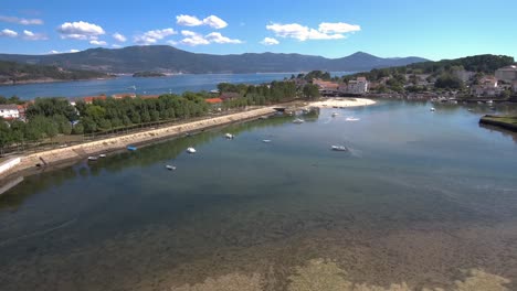 Aerial-Pan-Right-View-Across-Esteiro-Mainer-With-Boats-Moored-On-Clear-Sunny-Day