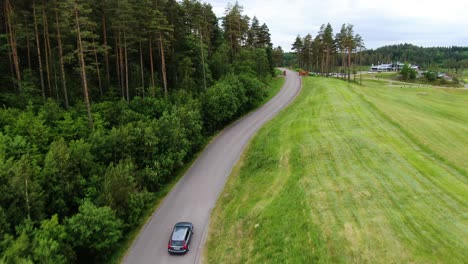 Car-driving-towards-Hills-Golf-Club-building-in-Molndal-near-Gothenburg,-Sweden
