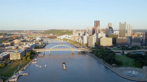 Aerial-drone-view-over-the-Allegheny-river,-golden-hour-in-downtown-Pittsburgh,-USA