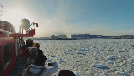 Tourists-Taking-Photos-Of-Drift-Sea-Ice-Onboard-Garinko-Go-II-Cruise-Ship-During-Sunset-Off-Mombetsu