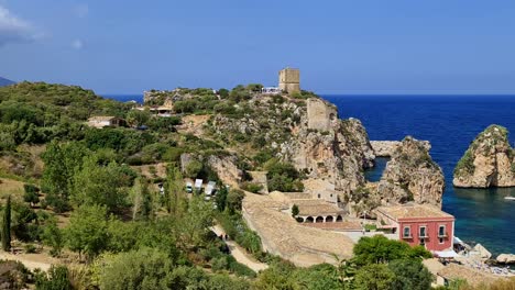 Stunning-panning-panoramic-view-of-Stacks-or-Faraglioni-of-Scopello-with-Tonnara-tuna-factory-and-Torre-Doria-tower-in-Sicily