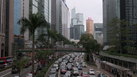 Traffic-jam-makes-their-way-slowly-along-a-road-surrounded-by-skyline-and-financial-skyscrapers-in-Hong-Kong