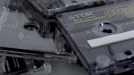 A-close-up-shot-panning-across-a-stack-of-TDK-cassette-tapes,-tapes-were-a-popular-media-for-music-and-recordings-in-the-early-80’s-and-90’s