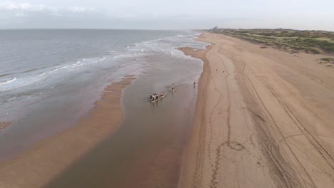 Aerial-View-Of-People-Riding-Horses-At-The-Beach-In-Katwijk,-Netherlands