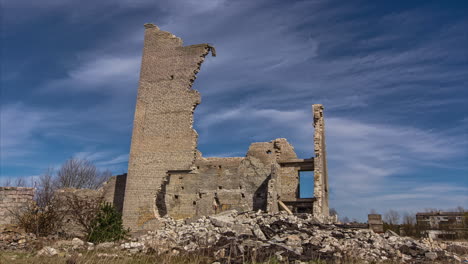 Time-lapse-shot-of-clouds-flying-on-blue-sky-behind-ancient-old-castle-ruin-wall-during-sunny-day