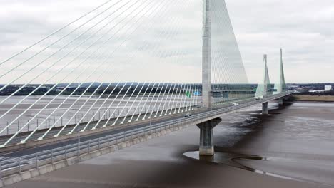 Mersey-gateway-landmark-aerial-view-above-toll-suspension-bridge-river-crossing-low-angle-pull-away-shot
