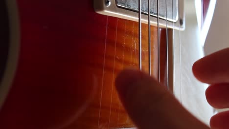Fingerpicking-nothing-else-matters-on-a-cherry-sunburst-Les-Paul-guitar
