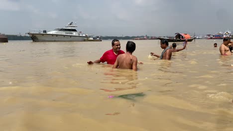 Close-up-video-of-people-are-taking-ritual-bath-in-the-river-Ganga