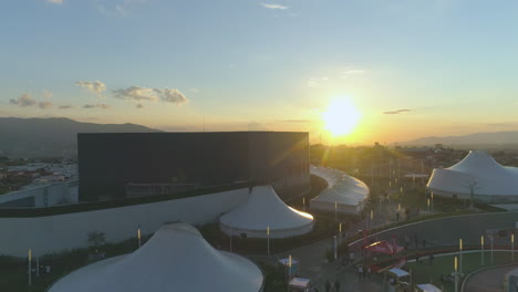 drone-video-in-shopping-mall-at-sunset,-outdoor,-sun-going-down,-white-marquee