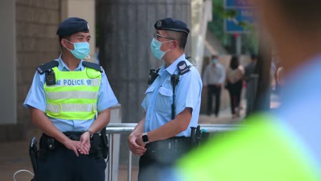 Police-officers-wearing-face-masks-stand-guard-at-the-High-Court-premises-in-Hong-Kong