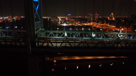 Side-profile-shot-of-suspension-bridge-at-night