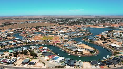 Aerial-orbiting-view-over-Wallaroo-Marina,-picturesque-Water-canal-shape,-Australia