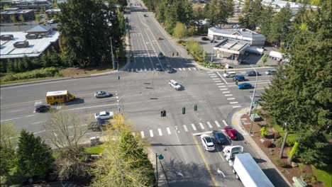 Aerial-timelapse-of-a-busy-intersection,-cars,-trucks,-and-traffic-moving-as-the-lights-change
