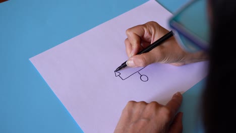 Female-Hand-Drawing-Basic-Genogram-Symbols-On-Plain-White-Paper
