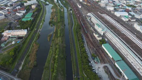 Aerial-view-of-Osaka-suburbs-of-Kadoma-city-with-Bullet-train-passing-4k