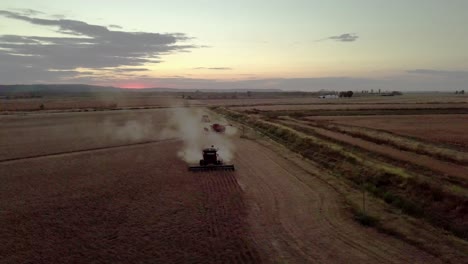 Farmer-uses-combine-to-harvest-wheat-barley-grain-soy-or-oat-field-in-fall-autumn-season-shot-with-aerial-drone-video-stock-17