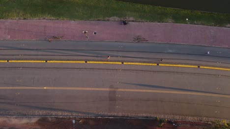 Top-down-aerial-view-of-man-jogging-by-road