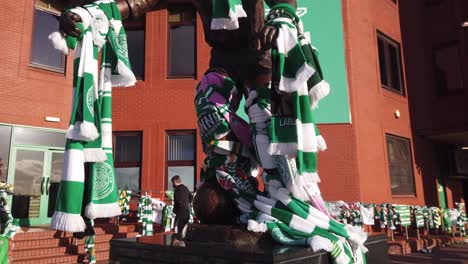 Close-up-of-the-statue-of-Celtic-FC-legend-Jimmy-Johnstone-with-scarves-being-tied-around-him