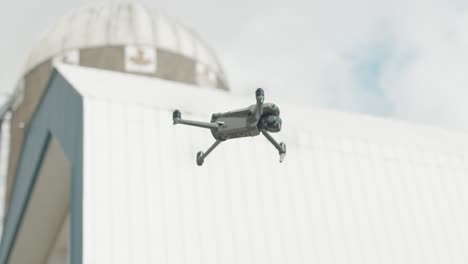 Drone-Camera-Flying-Against-Bokeh-Background-During-Daytime