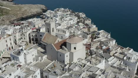 Aerial-view-with-ascending-orbit-of-Polignano-a-Mare-in-its-characteristic-white-color