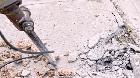 Jackhammer-breaking-asphalt.-Close-up-handheld
