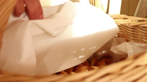 revealing-the-freshly-baked-traditional-Italian-stuffed-pastries-in-the-wicker-basket,-soft-natural-light