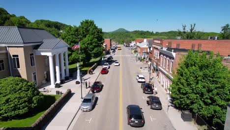 aerial-of-tazewell-virginia-with-tazewell-county-courthouse-and-flag-flying-outside-as-school-bus-passes-by